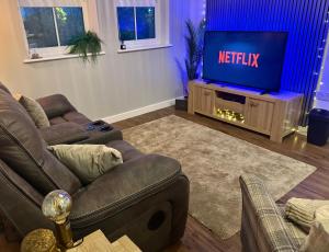 a living room with a couch and a tv at The Contractor Condo - Underground Parking in Aylesbury