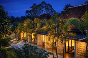 an exterior view of a resort with palm trees at Nirvana Hotel Resort Tetebatu in Tetebatu