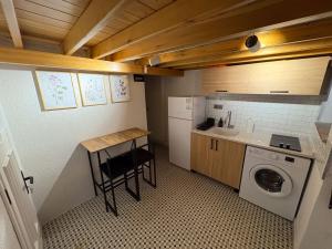 a small kitchen with a sink and a washing machine at Macaron The Pure Guest Houses in Ayvalık