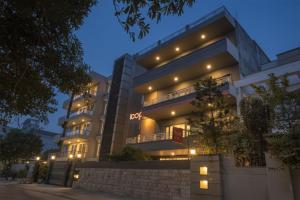 a large building with lights on it at night at Loop by Zolo Baani Square, Gurugram in Gurgaon