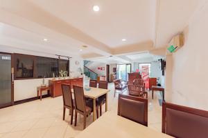 a kitchen and dining room with a table and chairs at RedDoorz Plus at Buah Batu in Bandung