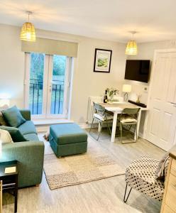 a living room with a couch and a table at The Coach House, Cleobury Mortimer in Cleobury Mortimer