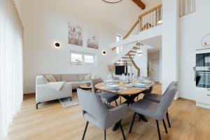 a dining room and living room with a table and chairs at Ferienhaus HeimatLay in Mörsdorf