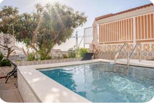 a swimming pool in the backyard of a house at Independent Apartment At Villa Noelia Benalmádena With Private Pool, Garden & Parking in Benalmádena