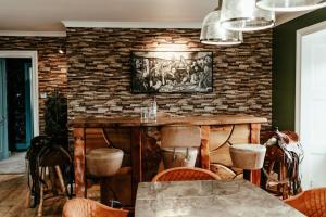 a dining room with a brick wall and a table and chairs at The Seadoor, Shetland Islands in Lerwick