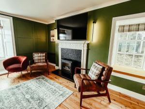 a living room with two chairs and a fireplace at The Seadoor, Shetland Islands in Lerwick +41 photos