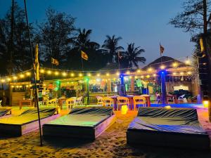 a group of beds on the beach at night at Beach Lovers Tiny House in Nilaveli