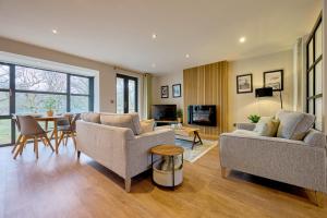 a living room with two couches and a table at Riverside Park 3 in Keswick