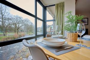a dining room with a table and a large window at Riverside Park 3 in Keswick
