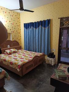 a bedroom with a bed and a window at Padda Farm house in Patiāla