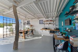 a room with a table and chairs and a blue wall at Saint Joris a tiny Boutique Resort in Willemstad