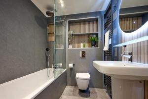 a bathroom with a white toilet and a sink at Riverside Park 3 in Keswick +45 photos