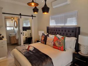 a bedroom with a large bed with pillows at Picasso Dreams in Kimberley