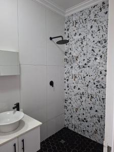 a bathroom with a sink and a shower at Unit 17 Sunbird Self-Catering in Richards Bay