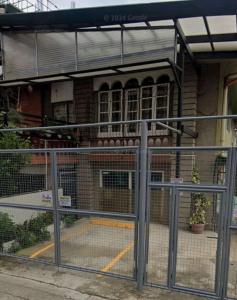 a gate in front of a building with a building at Secret Room Bliss in Baguio