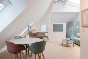 a living room with a table and chairs at Key Inn serviced residences Belair in Luxembourg