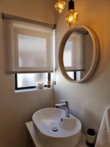 a bathroom with a sink and a mirror at Picasso Dreams in Kimberley