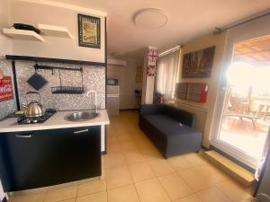 a kitchen with a sink and a couch in a room at Attico Sant'Anna - Silent Bay Apartments in Sestri Levante +30 photos