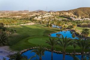 an aerial view of a golf course with palm trees at Paraíso Veracoast in Vera