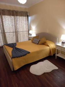 a bedroom with a bed and a white rug on the floor at Sunny Sunset House in Ponta do Pargo