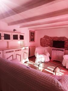 a living room with a couch and a tv at Villa La Pineta in Umbertide