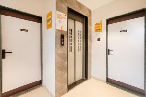 a row of three doors in a building at Itsy Hotels Lotus Executive in Pune +37 photos