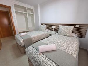 a bedroom with two beds and a window at Estrella y mar in La Estrella