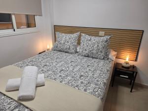 a bedroom with a large bed with two candles on it at Estrella y mar in La Estrella +36 photos