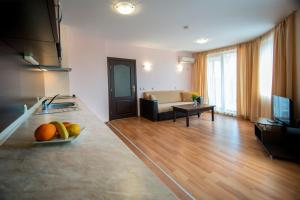 a living room with a bowl of fruit on a counter at South Beach Hotel - New Management and Free Beach Access in Tsarevo