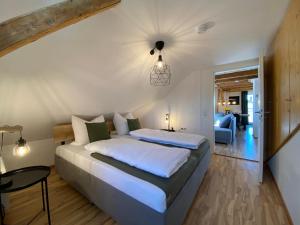 a bedroom with a large bed and a living room at Modernes 3-Familienhaus im Allgäu in Erkheim