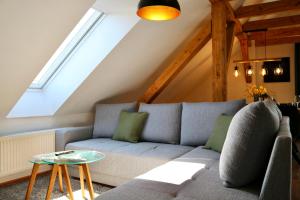 a living room with a couch and a table at Modernes 3-Familienhaus im Allgäu in Erkheim