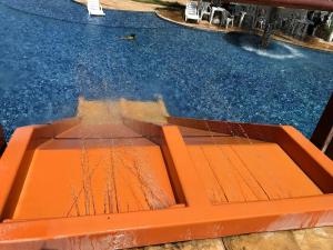 an orange platform in a swimming pool with water at Beach Living, Frente mar, Vizinho B Park - Oficial in Mangabeira