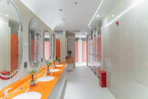 a bathroom with a row of sinks and mirrors at SilMiCore Hostel in Shanghai