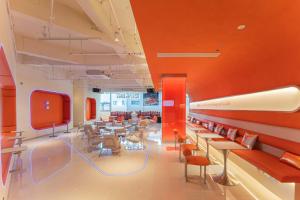 a large room with tables and chairs and a tv at SilMiCore Hostel in Shanghai +53 photos