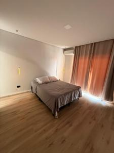 a bedroom with a bed and a large window at Espaço prime piscina aquecida in Sorocaba +21 photos