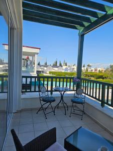 a patio with chairs and a table on a balcony at Quiet 61 Perivolia in Meneou