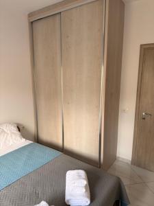 a bedroom with a bed with a large closet at Vana's Apartments in Sarandë