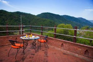 a table and chairs on a brick patio with a view at Dahlia Boutique Hotel in Pokhara