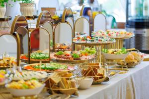 a buffet with many plates of food on a table at Dwór Prezydencki Boutique Hotel & SPA in Tarnów