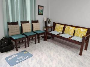 a living room with four chairs and a table at Loida and Juns Homestay in Butuan