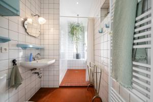 a bathroom with a sink and a bath tub at Maison Nice - Plage 300m - Parking in Nice