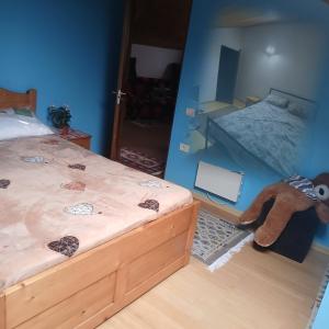 a bedroom with a bed and a stuffed animal at Cărăbuș in Tuzla