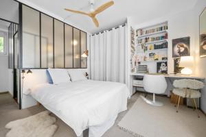 a bedroom with a white bed and a desk at Maison Nice - Plage 300m - Parking in Nice
