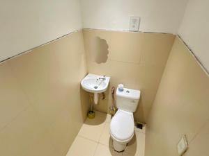 a small bathroom with a toilet and a sink at El Nido's View in El Nido