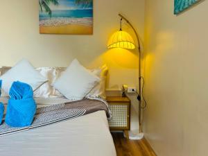 a bedroom with a bed with a lamp next to it at El Nido's View in El Nido