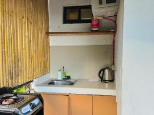 a small kitchen with a sink and a stove at El Nido's View in El Nido