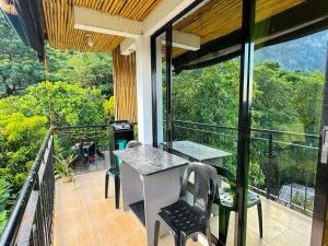 a balcony of a house with a table and chairs at El Nido's View in El Nido