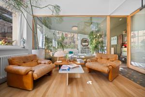 a living room with two chairs and a table at Maison Nice - Plage 300m - Parking in Nice