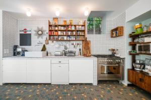 a kitchen with white cabinets and a stove at Maison Nice - Plage 300m - Parking in Nice