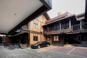 a car parked in a parking lot in front of buildings at RedDoorz @ Cilandak Timur in Jakarta
